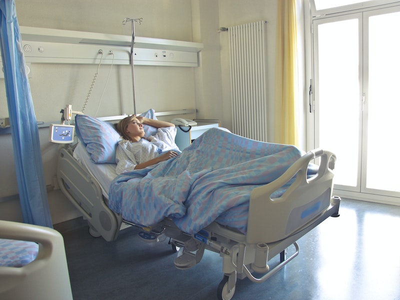 Woman Lying in Hospital Bed