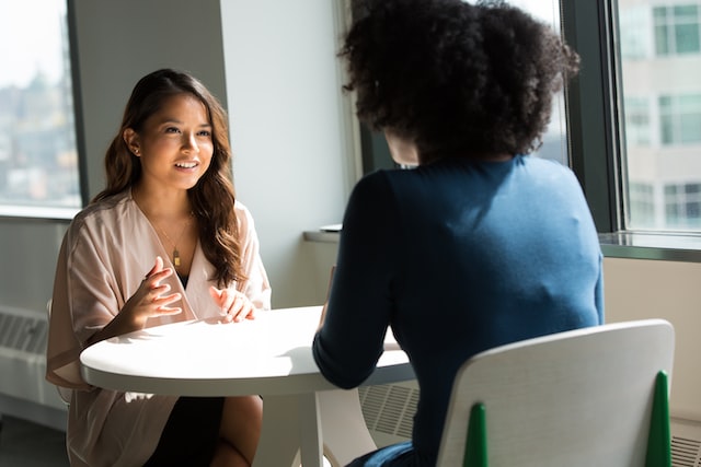 women on chair discussing