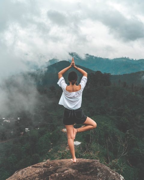 woman yoga pose on rock