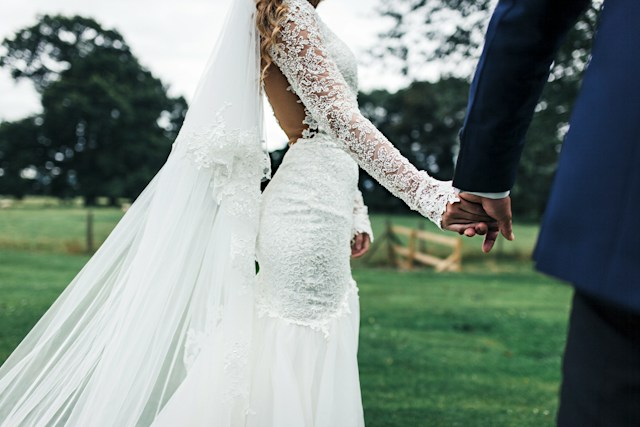 bride and groom holding hands