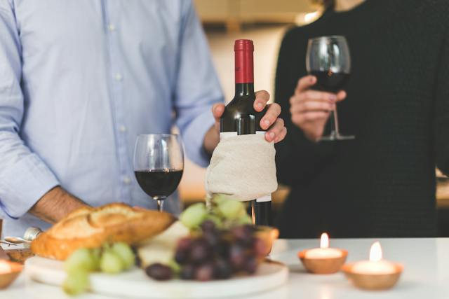 holding wine bottle
