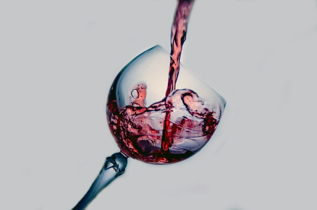 tilted wine glass having red nectar