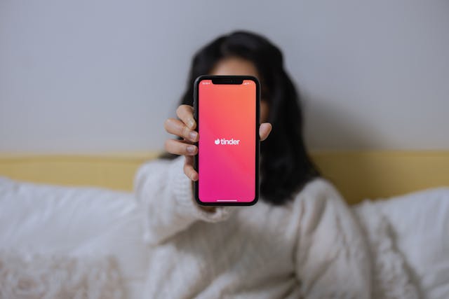 A Woman Showing Her Smartphone tinder